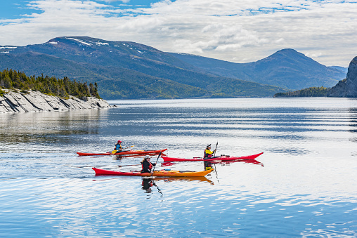 Tourists are playing Kayak at Neddy Harbour, Norris Point, Newfoundland and Labrador, Canada.