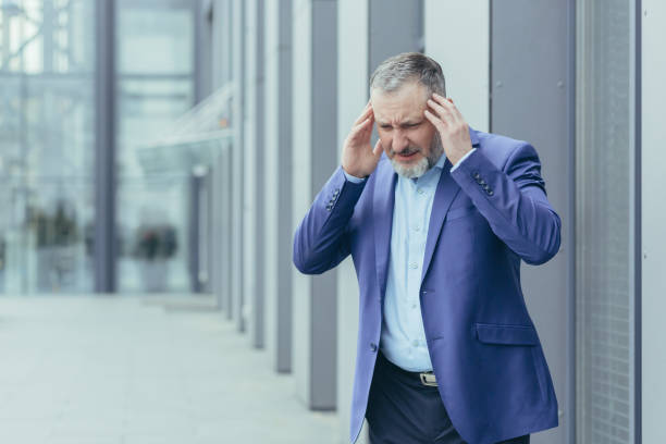 istock Nervous breakdown, exhaustion. Senior man businessman holds his head with both hands 1423710704