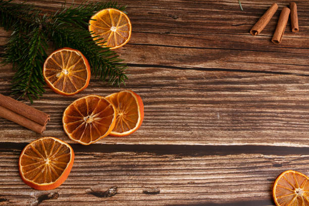 Wooden table with dried orange slices and cinnamon for Christmas