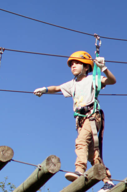istock kids doing adventure crossing over bridges 1423713599