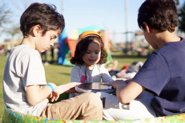 istock children playing on a merry-go-round 1423713639