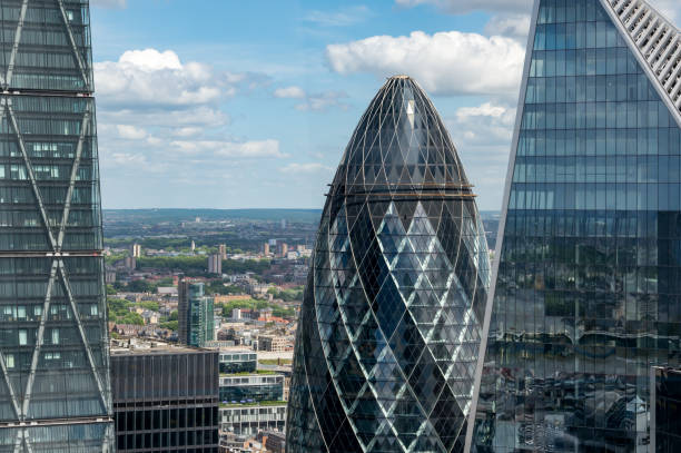 Elevated view of the glass skyscraper building known as The Gherkin at 30 St Mary Axe in the financial district of London