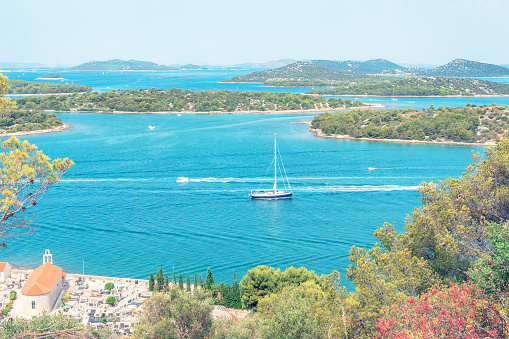 A sailboat in the sea with islands. Murter, Croatia.