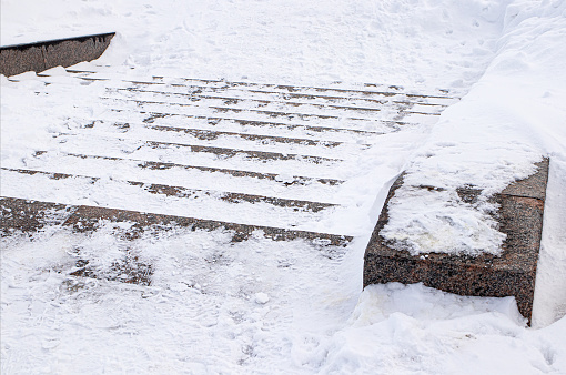 Winter. Stairs. Danger of accident on snow-covered slippery steps.