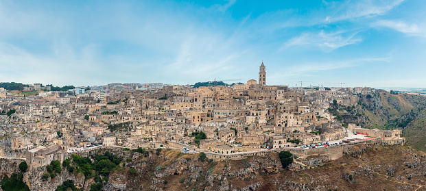 Ancient Unesco heritage old town of Matera (Sassi di Matera), Basilicata, southern Italy. Prehistoric cave dwellings, European Capital of Culture 2019. People are unrecognizable.