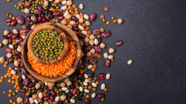 istock Different beans, lentils, mung or maash, chickpeas in wooden bowls 1423720013