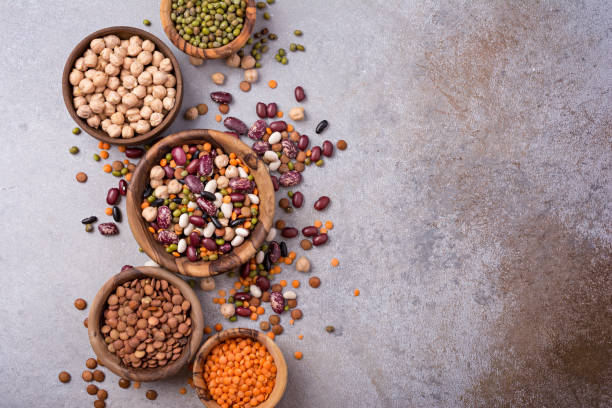 istock Different beans, lentils, mung, chickpeas in wooden bowls 1423720076