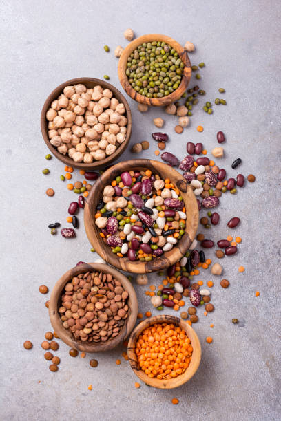 istock Different beans, lentils, mung, chickpeas in wooden bowls 1423720083