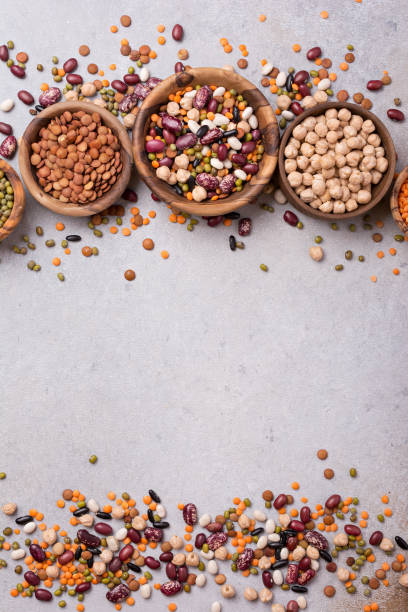 istock Different beans, lentils, mung, chickpeas in wooden bowls 1423720084