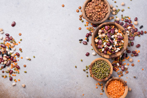 istock Different beans, lentils, mung, chickpeas in wooden bowls 1423720092