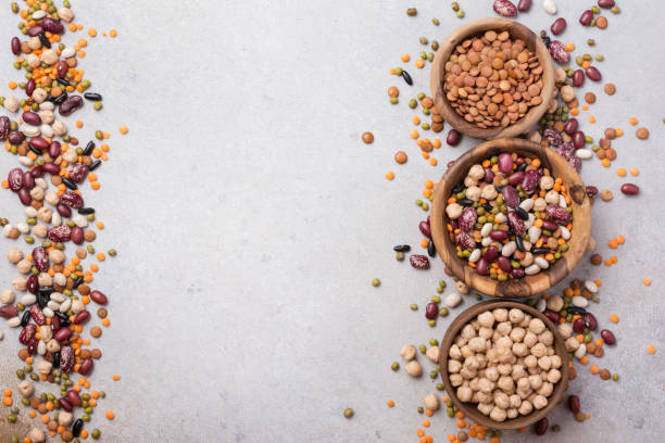 istock Different beans, lentils, mung, chickpeas in wooden bowls 1423720102