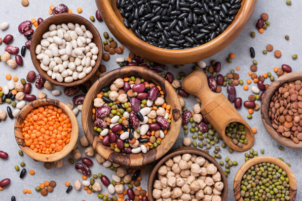 istock Different beans, lentils, mung, chickpeas in wooden bowls 1423720119