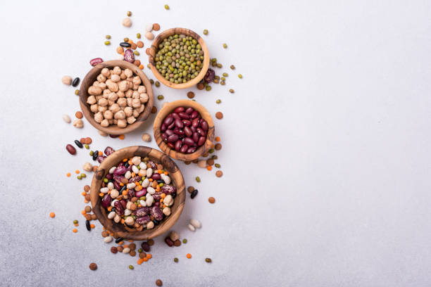 istock Different beans, lentils, mung, chickpeas in wooden bowls 1423720148