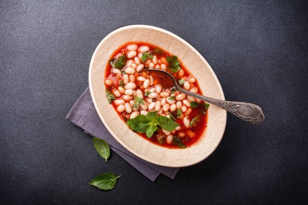 istock Dish with beans in tomato sauce with fresh basil 1423720240