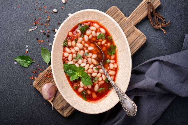 istock Dish with beans in tomato sauce with fresh basil 1423720314
