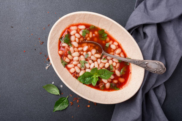 istock Dish with beans in tomato sauce with fresh basil 1423720347