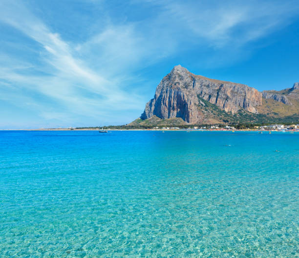 Paradise Tyrrhenian sea bay, San Vito lo Capo beach with clear azure water and extremally white sand, and Monte Monaco in far, Sicily, Italy. People unrecognizable.