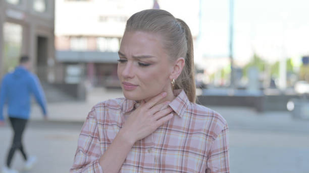 istock Young Woman Coughing while Standing Outdoor 1423721655