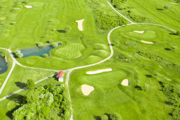 istock Golf course with sand bunker, green grass and pond, aerial view 1423726855