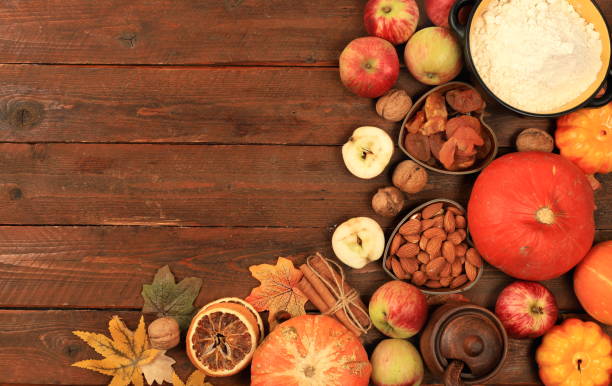 istock Kitchen background with pumpkin, apples, spices, nuts, flour, eggs with place for menu, cooking concept, ingredients for pumpkin and apple pies recipe 1423730834