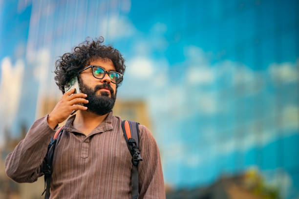 istock Man with backpack talking on phone outdoor downtown 1423732817