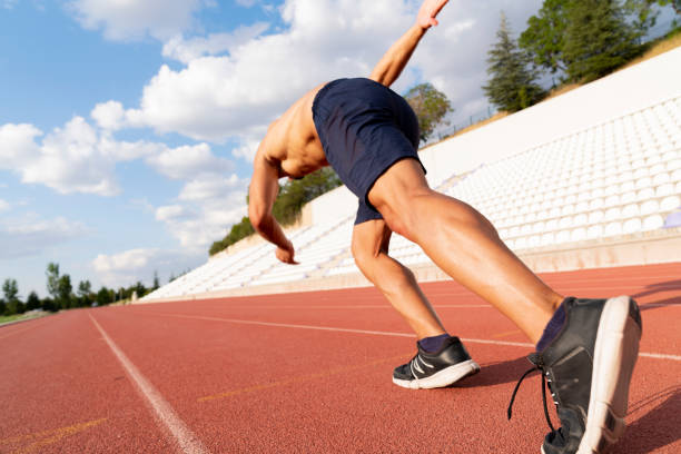 istock Runner using starting block to start his run on running track in a stadium. athlete starting his sprint on an all-weather running track. 1423734273