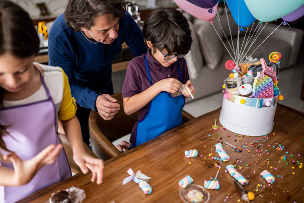 istock Siblings opening and playing with sweets on a children's day at home 1423734575