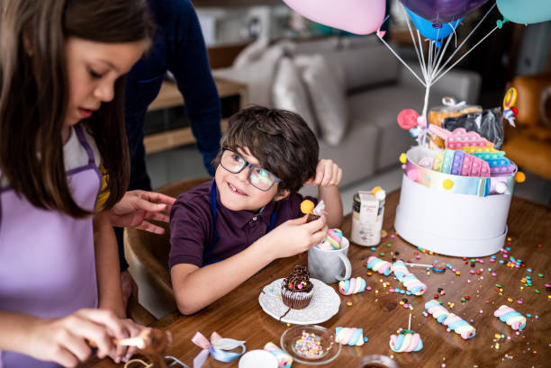 istock Siblings opening and playing with sweets on a children's day at home 1423734580
