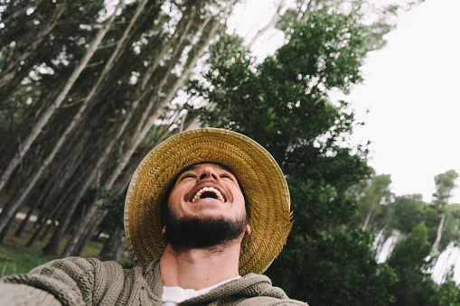 man smiling enjoying traveling and getting to know nature