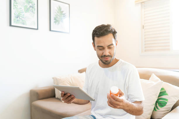 istock Young latin man checking medication usage by telemedicine with digital tablet 1423737603