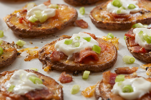 Twice Baked Loaded Potato Slices with Cheddar Cheese, Bacon, Green Onions and Sour Cream