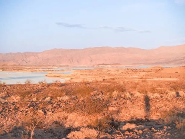 Lake mead, water reservoir surrounded by desert land and landforms in Nevada.