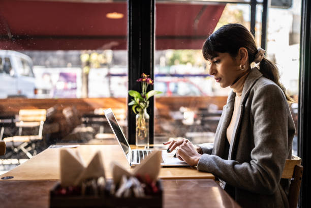 istock Young business woman working using laptop at coffee 1423739696
