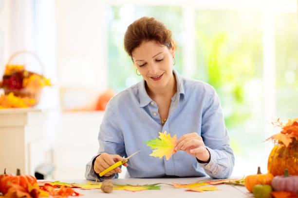 istock Autumn home decoration. Family decorating house. 1423743521