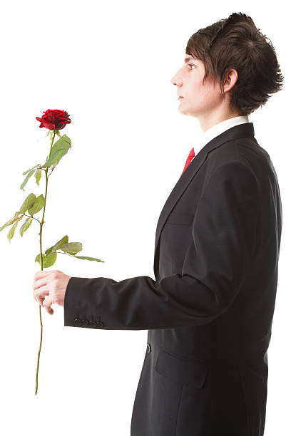 istock Young man presenting a flower red rose isolated 142374465