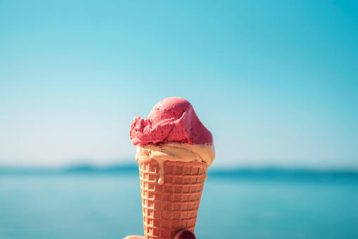 Ice cream in a cone on the background of the sea.