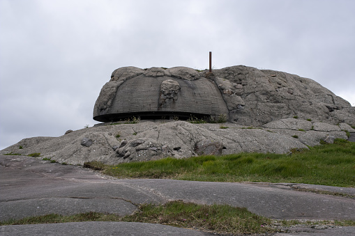 Sirevag, Norway - June 3, 2022: Sirevag Fort (HKB 18/978 Ogna) is an ex-German coastal battery located on Vedafjellet. It was completed in the summer of 1943 with four 88 mm guns. Selective focus.