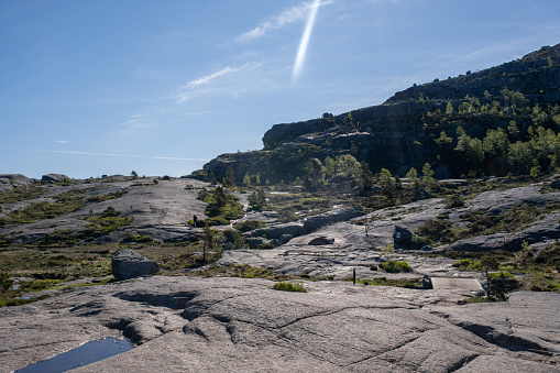 Strand, Norway - June 6, 2022:  Wonderful landscapes in Norway. Walking through the path to the Preikestolen pulpit rock. Sunny spring day