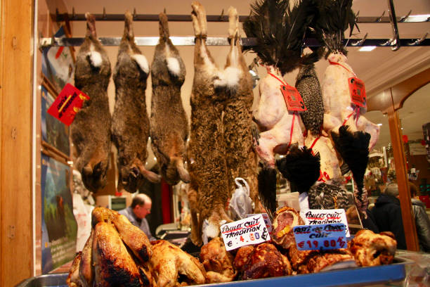 Horizontal closeup photo of the colorful window display in a Parisian shop selling different kinds of game meats in Winter. \nParis, France. 23rd November 2016.