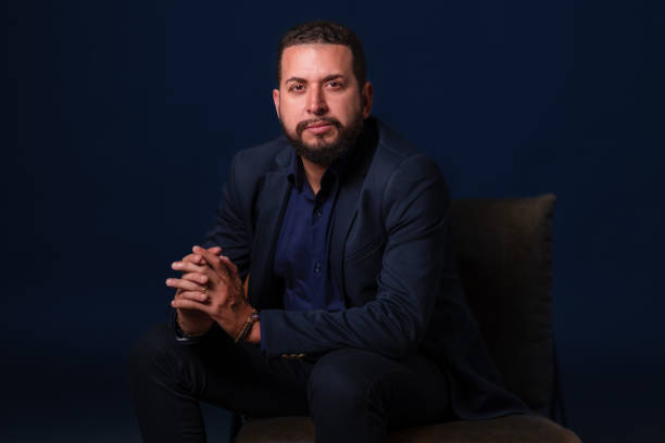 istock businessman portrait with dark blue background 1423756729