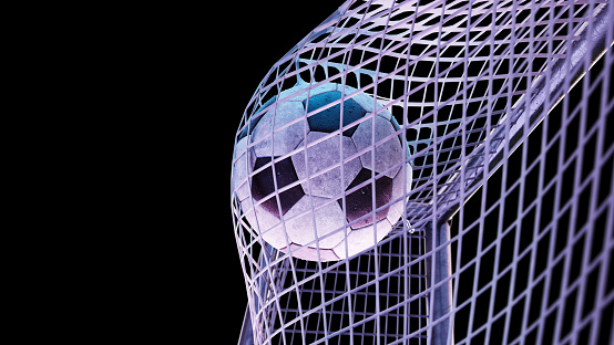 Soccer ball hits the goal, isolated on a black background. Ball in the net of a football goal, night lighting, close-up. 3D Render, selective focus.