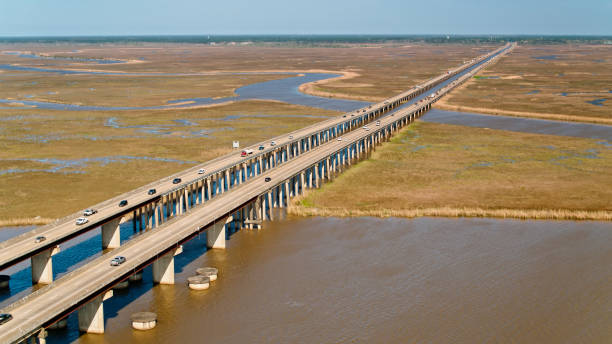 Drone Shot of Interstate 10 Near Gautier, Mississippi Aerial establishing shot of Interstate 10 crossing the Pascagoula River near Gautier, Mississippi mississippi delta stock pictures, royalty-free photos & images