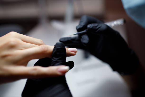 istock Manicure process female hands finger nails polish 1423766182