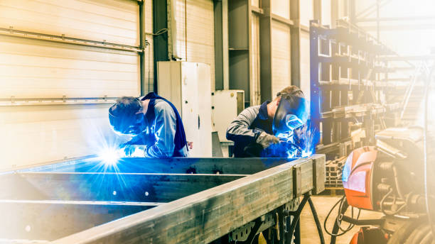 istock Pair of professionals working together on one steel construction 1423766346