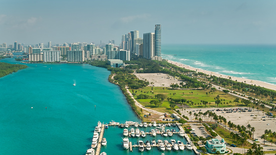 Aerial shot of Miami on a sunny spring day, looking across Haulover Park and the northern end of Biscayne Bay towards Sunny Isles Beach.
