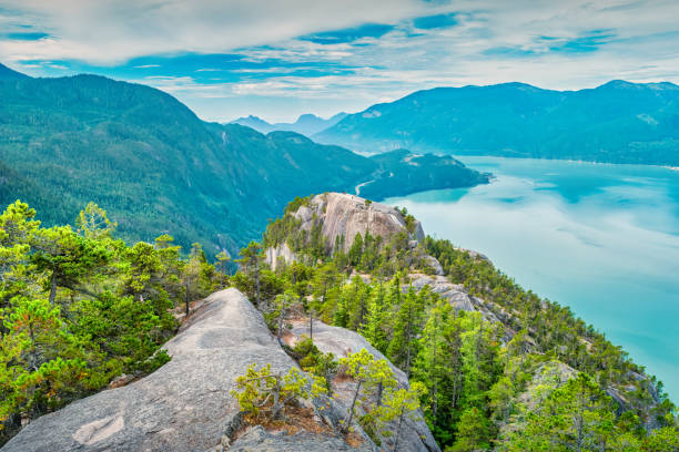 View of hikers on Stawamus Chief Mountain and Howe Sound, near Squamish, BC, Canada.