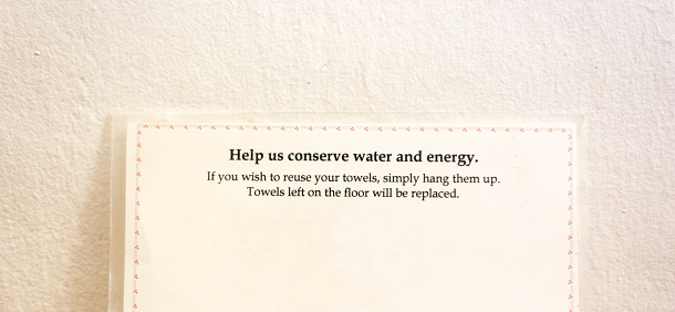 Hotel Room Sign: Help Us Conserve Water and Energy. Shot in a hotel room in Southwest USA.
