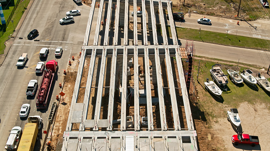 High angle drone shot of the concrete frame of a new overpass for Highway 146 in Kemah, Texas.