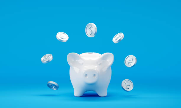 istock Piggy bank with falling dollar coins on blue background 1423776161
