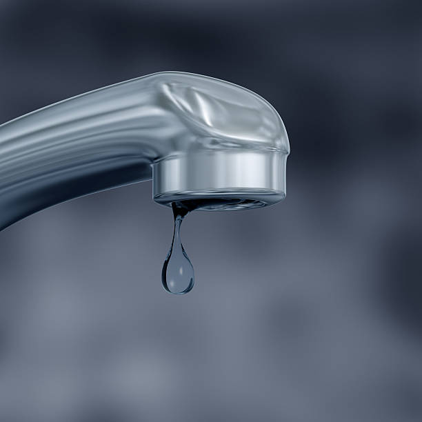 istock Water faucet closeup with a single water drop hanging off 142378483